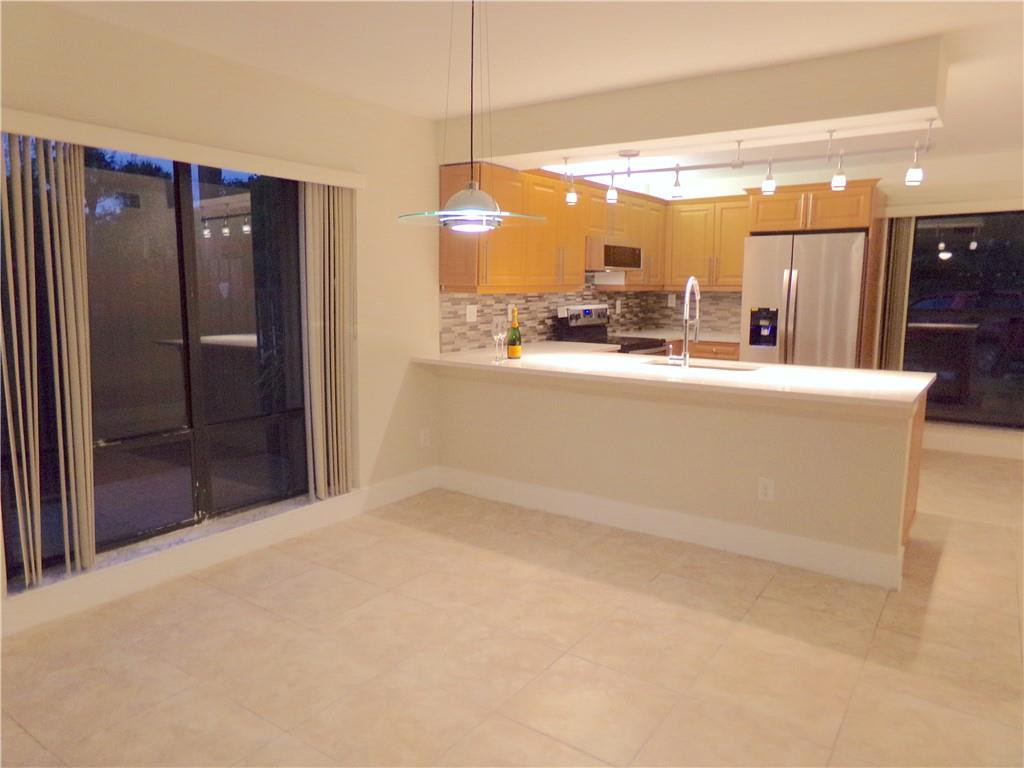 8205 Boca Rio Drive, Unit 8205 Boca Raton, FL 33433 - Photo 17 of 17 a view of a kitchen with a refrigerator a sink and a dishwasher