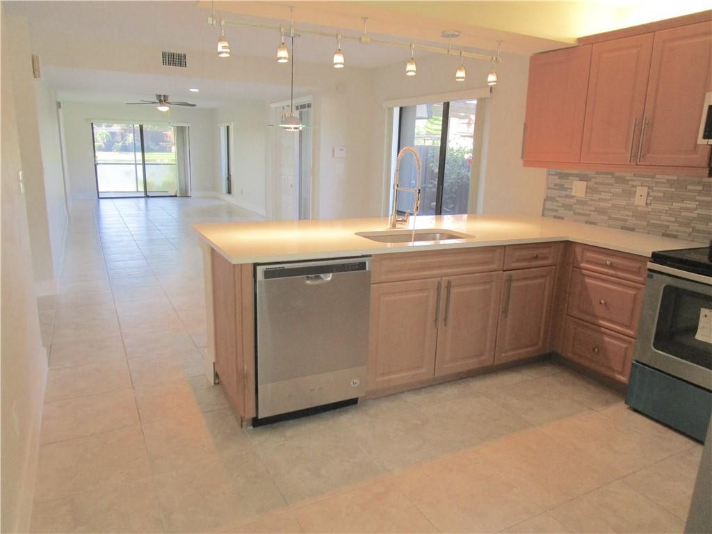8205 Boca Rio Drive, Unit 8205 Boca Raton, FL 33433 - Photo 3 of 17 a large bathroom with a sink a washer and dryer