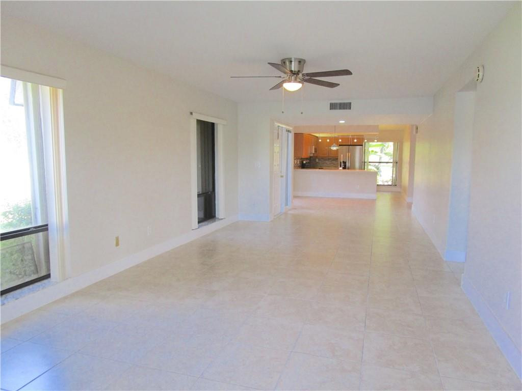 8205 Boca Rio Drive, Unit 8205 Boca Raton, FL 33433 - Photo 4 of 17 a view of a room with a stylish ceiling fan and window