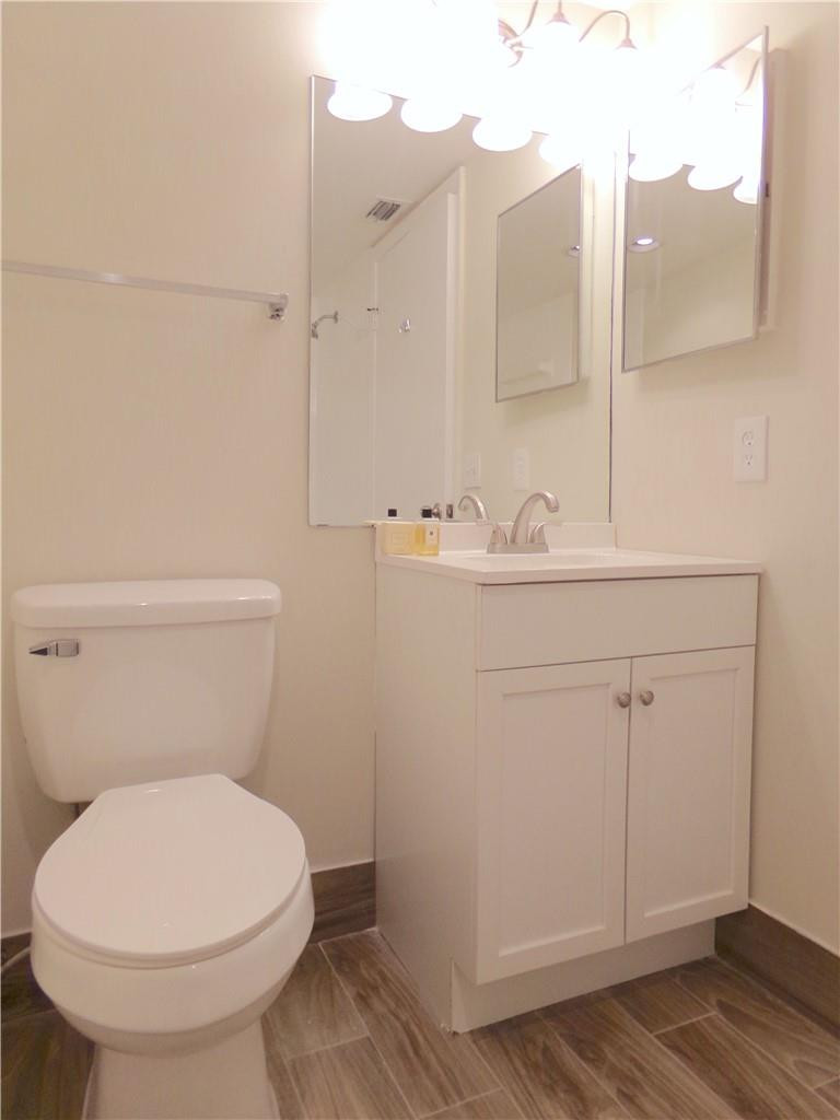 8205 Boca Rio Drive, Unit 8205 Boca Raton, FL 33433 - Photo 9 of 17 a bathroom with a sink a toilet and shower