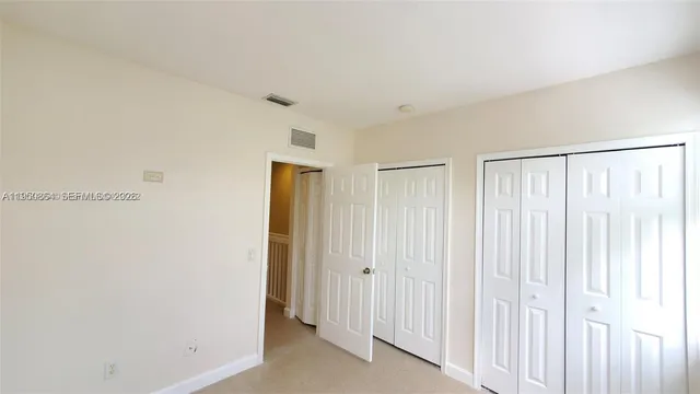 a view of a room with a wooden door