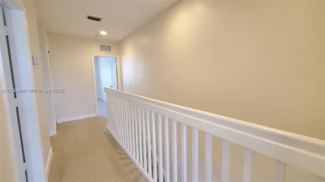 a view of an empty room and a window