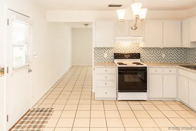 a kitchen with a stove top oven cabinets and a sink