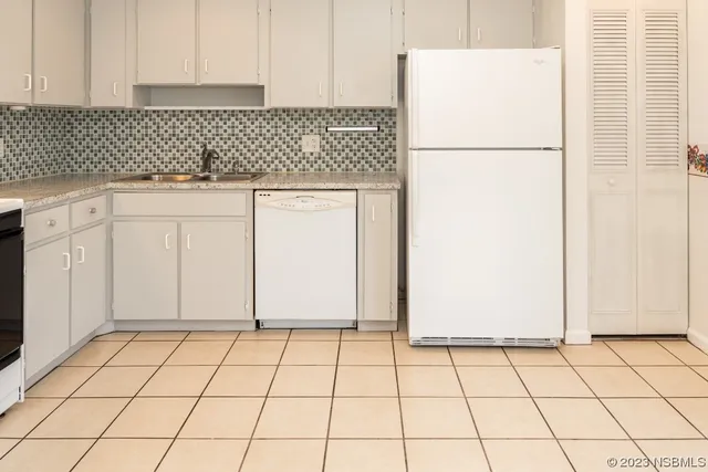 a view of a kitchen with white cabinets