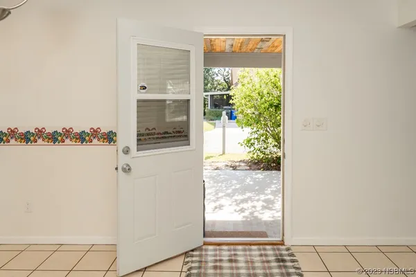 a picture of a kitchen with a refrigerator and a window