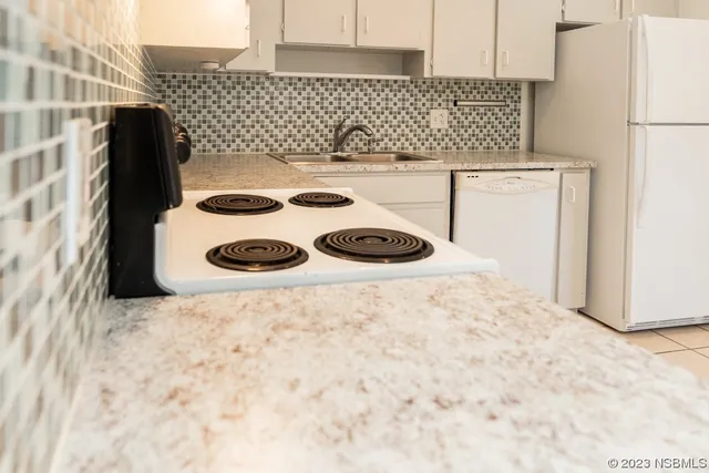 a kitchen with a stove and a refrigerator