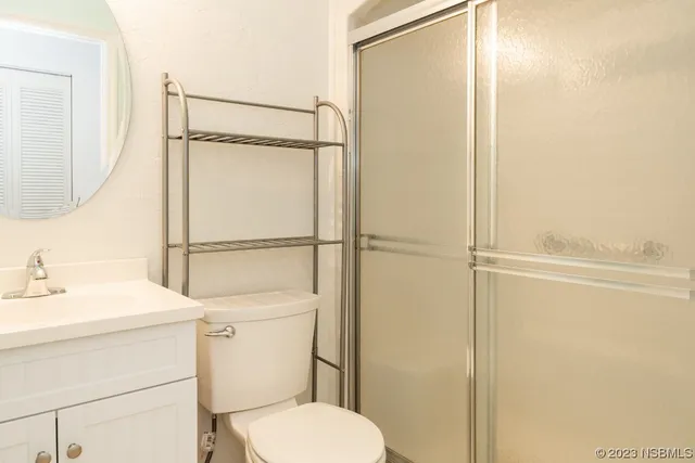 a bathroom with a toilet a sink and a mirror