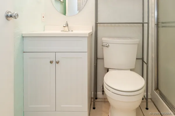 a bathroom with a toilet sink and a mirror
