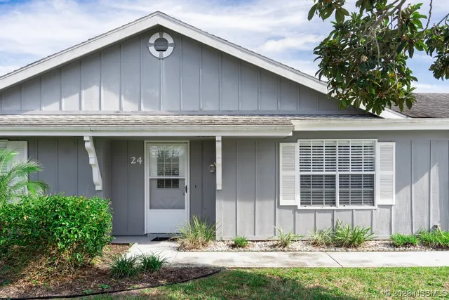 a front view of a house with a yard garage and outdoor seating