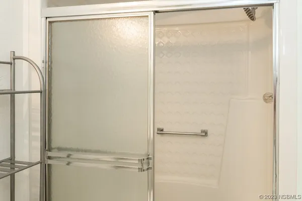a bathroom with a glass shower door