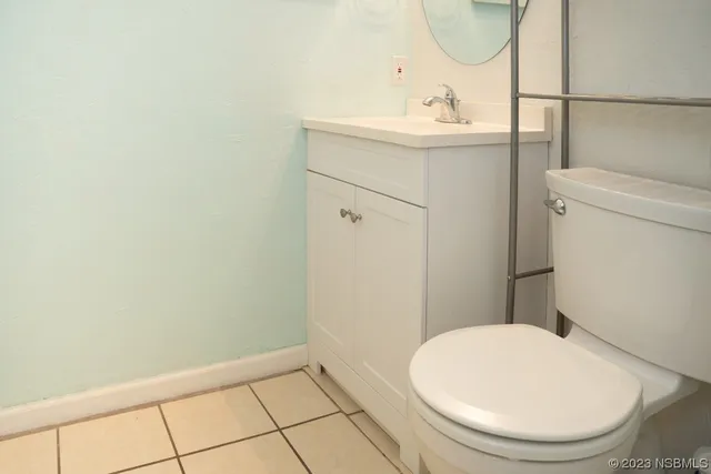 a bathroom with a sink toilet and a mirror