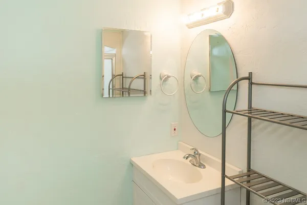 a bathroom with a sink a mirror and a shower