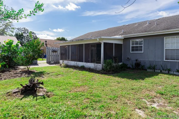 a view of a house with a backyard and garden