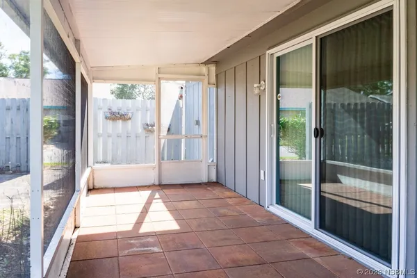 a bathroom with a tub mirror and glass door