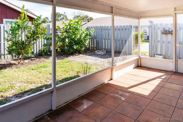 a view of a balcony with floor to ceiling windows with wooden floor