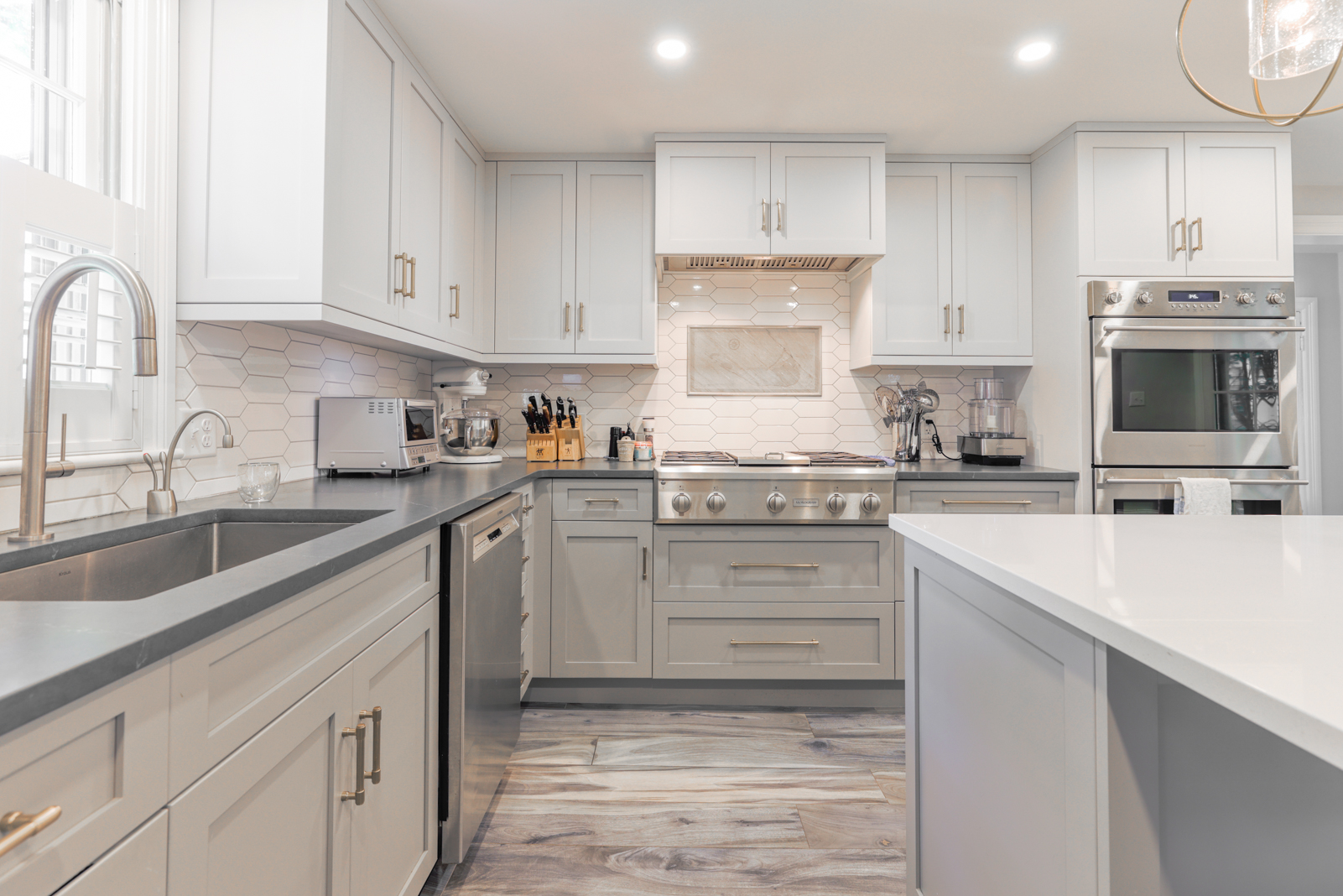 12 Hussey Street Nantucket, MA 02554 - Photo 9 of 47 a kitchen with kitchen island white cabinets and white appliances