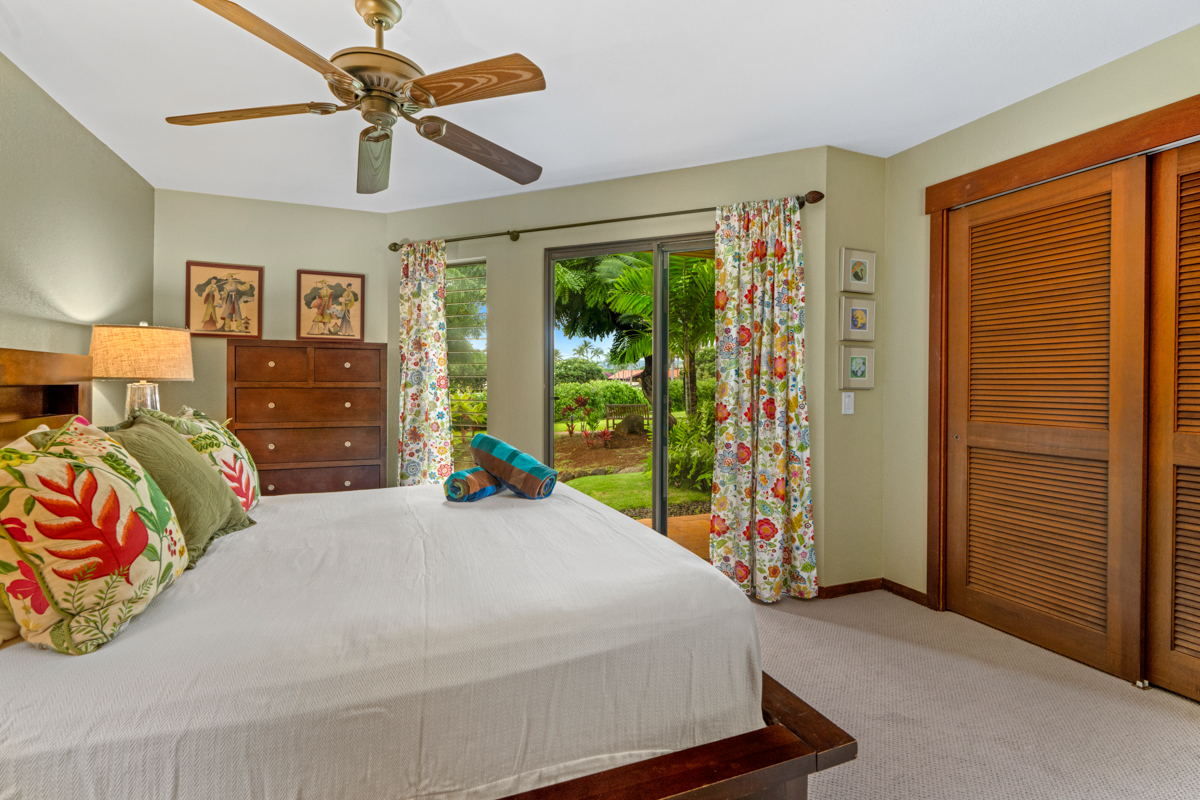 1870 Hoone Road, Unit 602 Koloa, HI 96756 - Photo 13 of 26 a bedroom with a bed and a chandelier