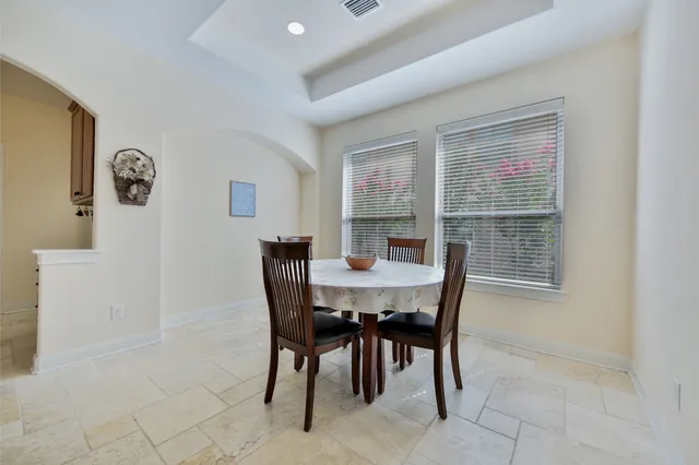 a view of an empty room with window and cabinet