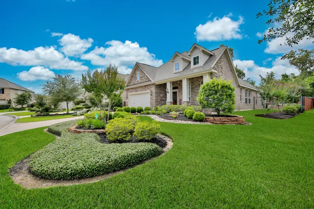 an empty room with wooden floor mirror and windows