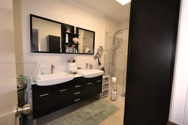 a bathroom with a double vanity sink and mirror