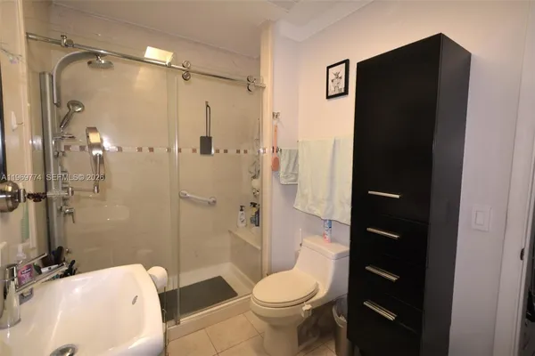 a bathroom with a toilet a sink and shower