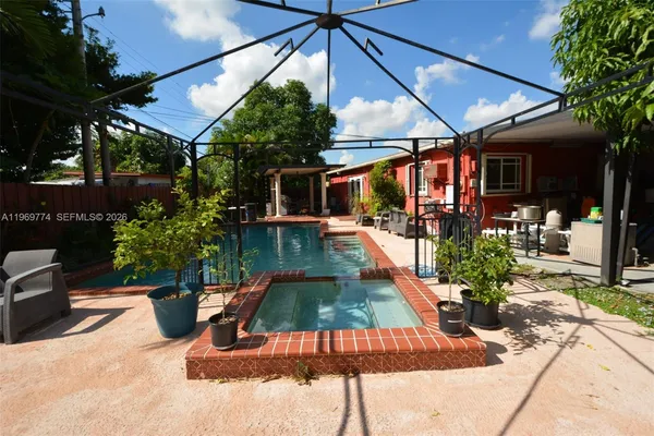 a view of a backyard with sitting area