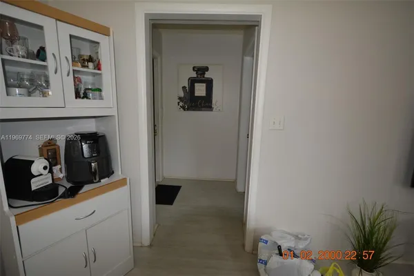 a kitchen with a refrigerator and cabinets