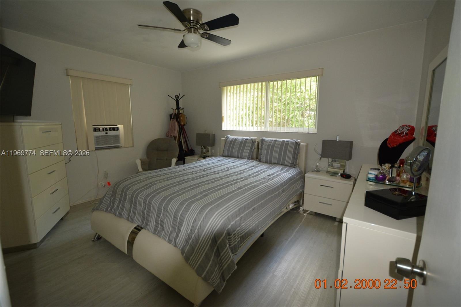 890 East 38th Street Hialeah, FL 33013 - Photo 27 of 30 a bedroom with a bed and a flat tv screen on the dresser