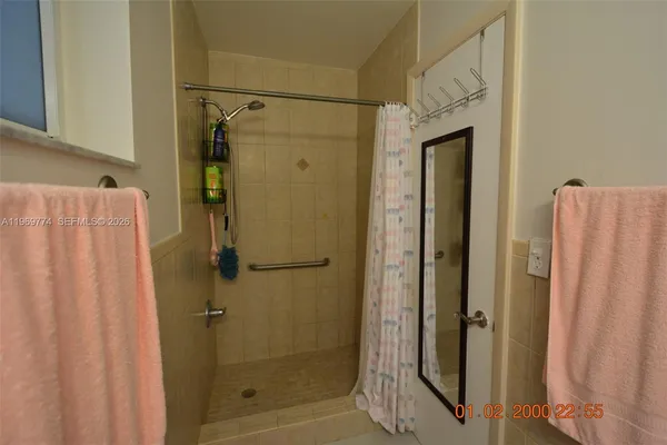 a bathroom with a shower and a glass door