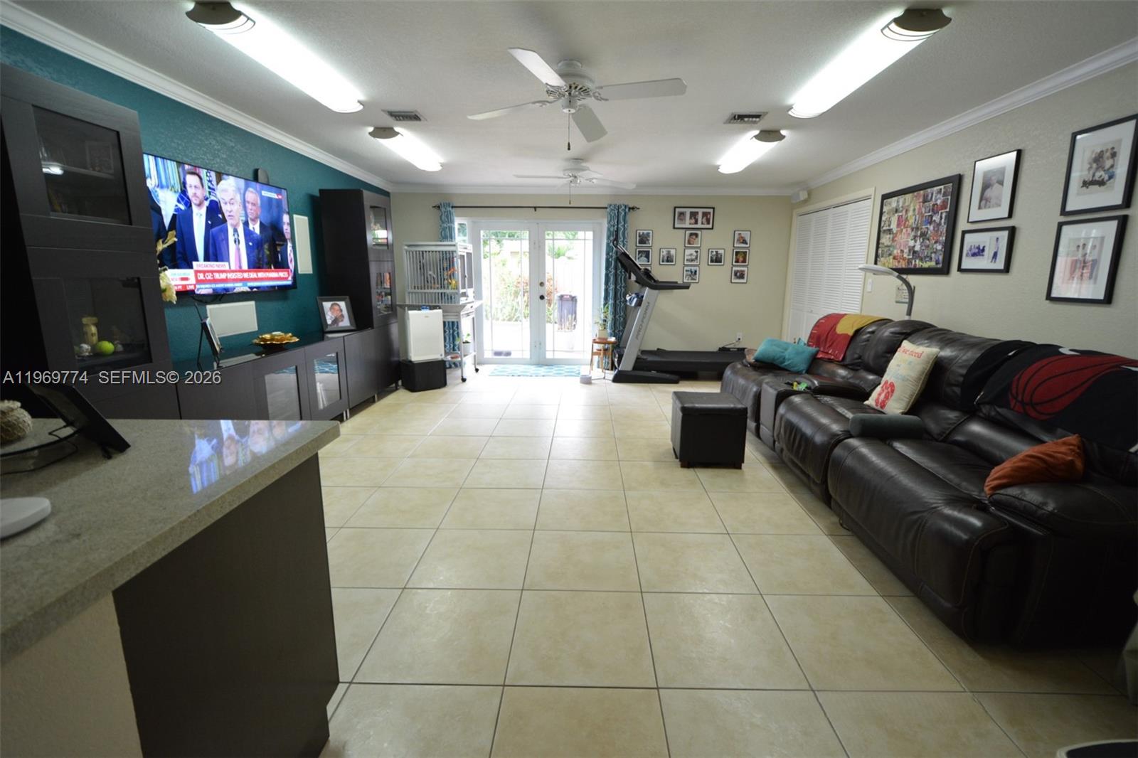 890 East 38th Street Hialeah, FL 33013 - Photo 4 of 30 a living room with furniture and a flat screen tv