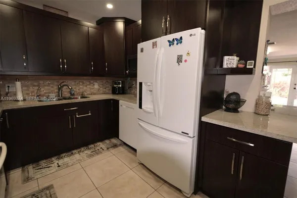 a white refrigerator freezer sitting inside of a kitchen