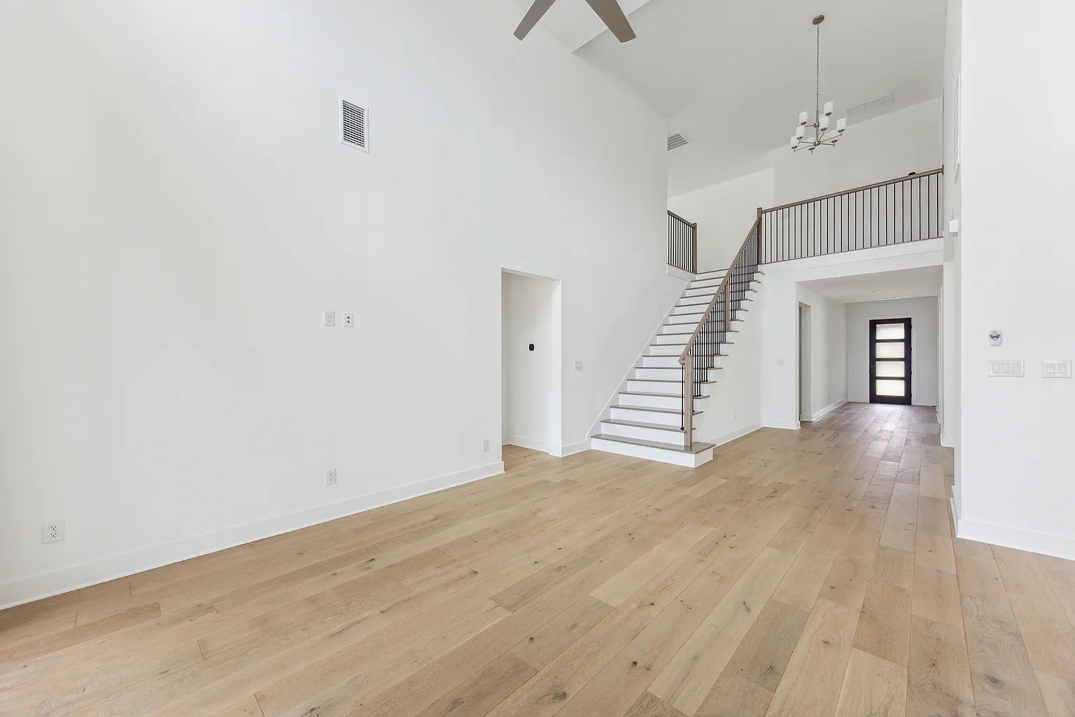 1909 Varese Path Leander, TX 78641 - Photo 10 of 40 A spacious entry features soaring ceilings, a graceful staircase, and durable hardwood flooring.