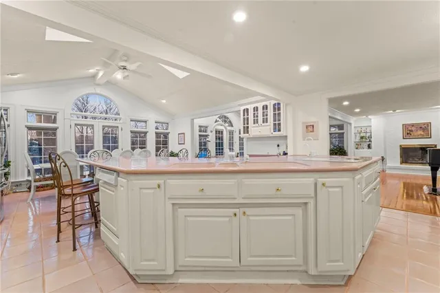 a kitchen with cabinets and chairs