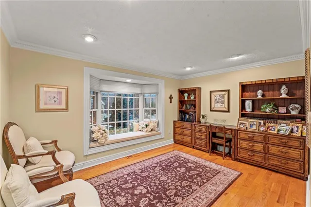 a living room with furniture and dresser
