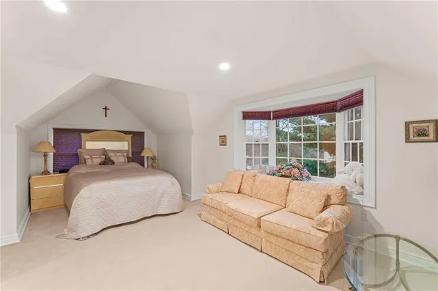 a bedroom with a large bed and a large window