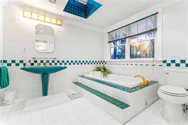 a bathroom with a sink mirror vanity and a toilet