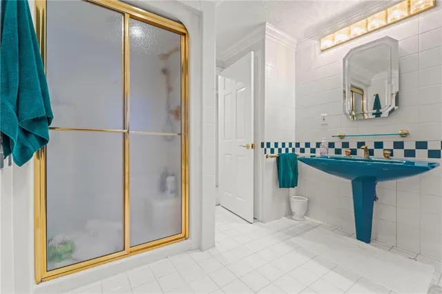 a room with kitchen island and white cabinets