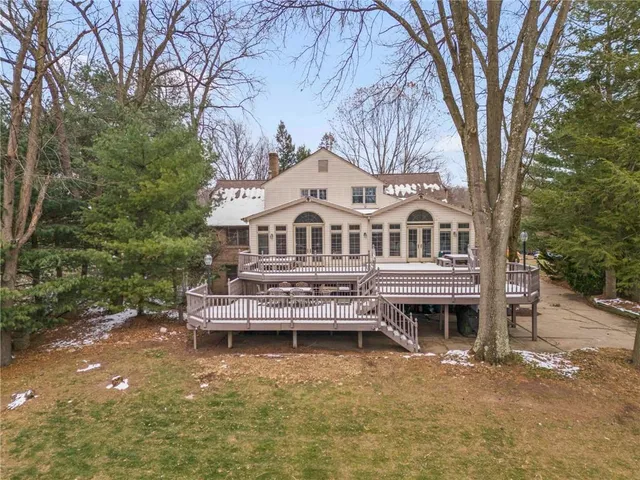 a view of house with outdoor space and sitting area