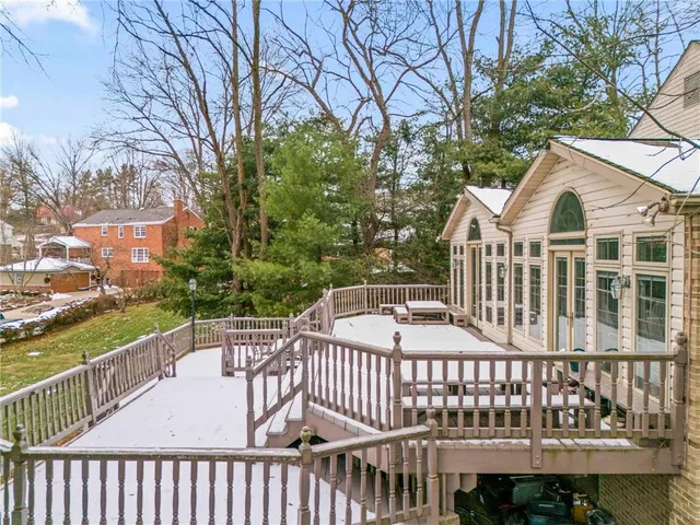 a view of a wooden chairs and iron fence