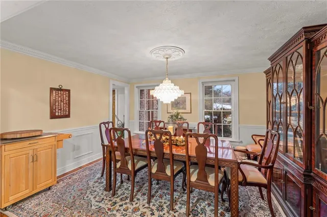 a view of a dining room with furniture and chandelier