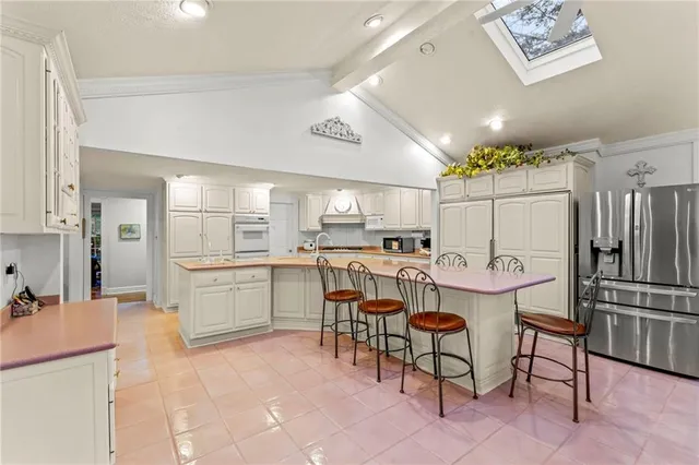 a kitchen with cabinets and chairs