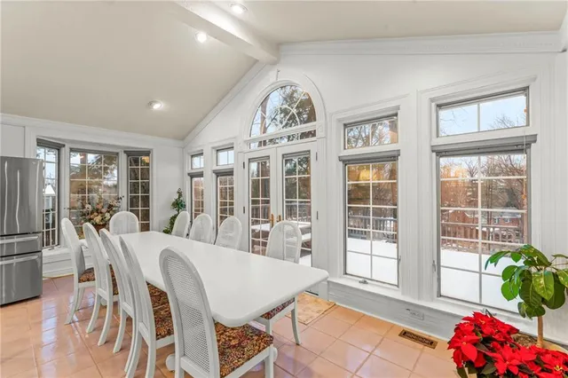 a view of a dining room with furniture and a chandelier