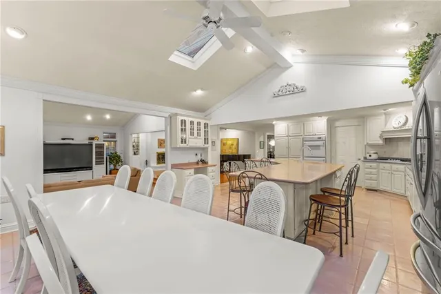 a large kitchen with a table and chairs