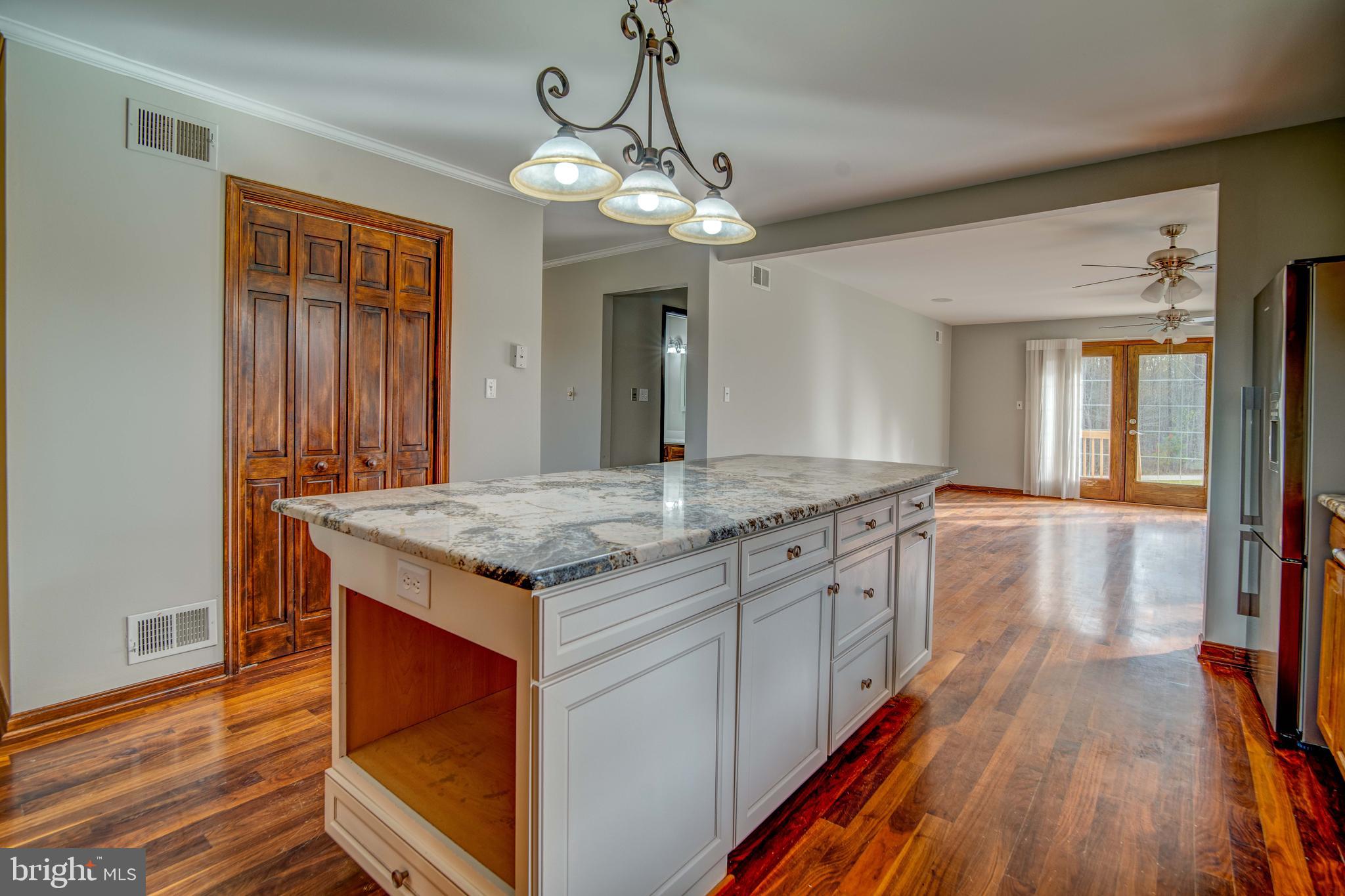 49530 Will's Road Dameron, MD 20628 - Photo 8 of 51 a kitchen with stainless steel appliances granite countertop a stove and cabinets with wooden floor