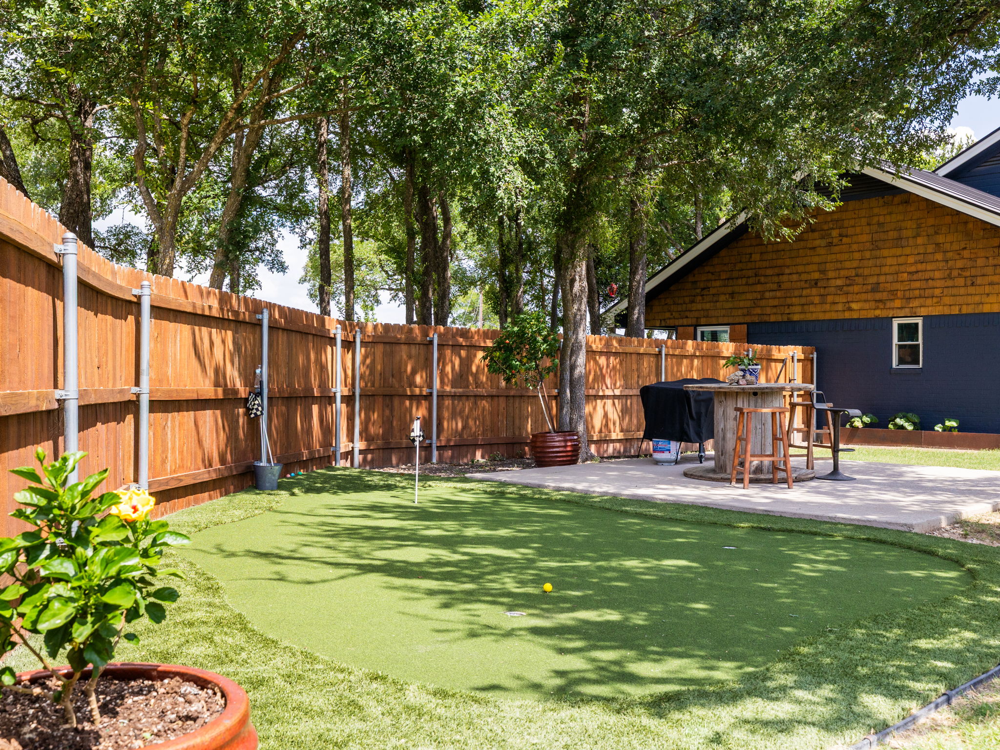 3001 County Road 255 Georgetown, TX 78633 - Photo 25 of 35 A private backyard oasis features a putting green alongside a paved patio perfect for outdoor entertaining.