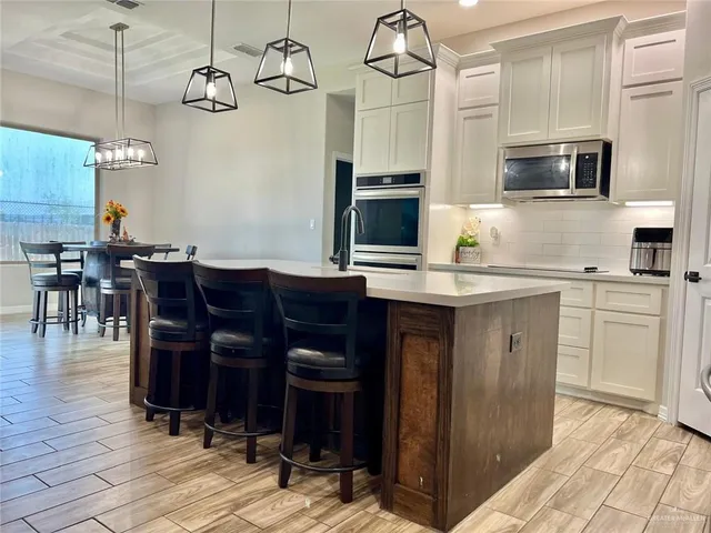 a kitchen with a sink cabinets and wooden floor
