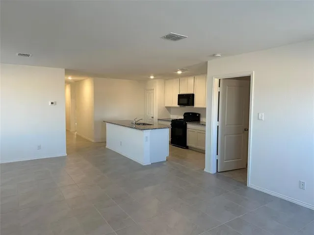 a view of a kitchen with a sink and cabinets