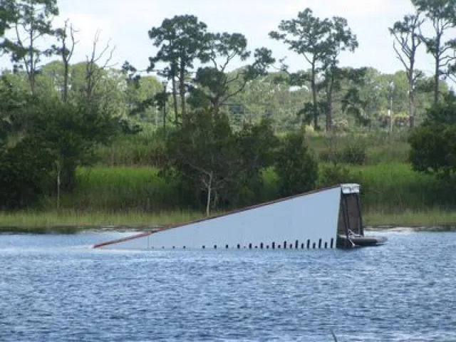 a view of a wooden fence next to a lake