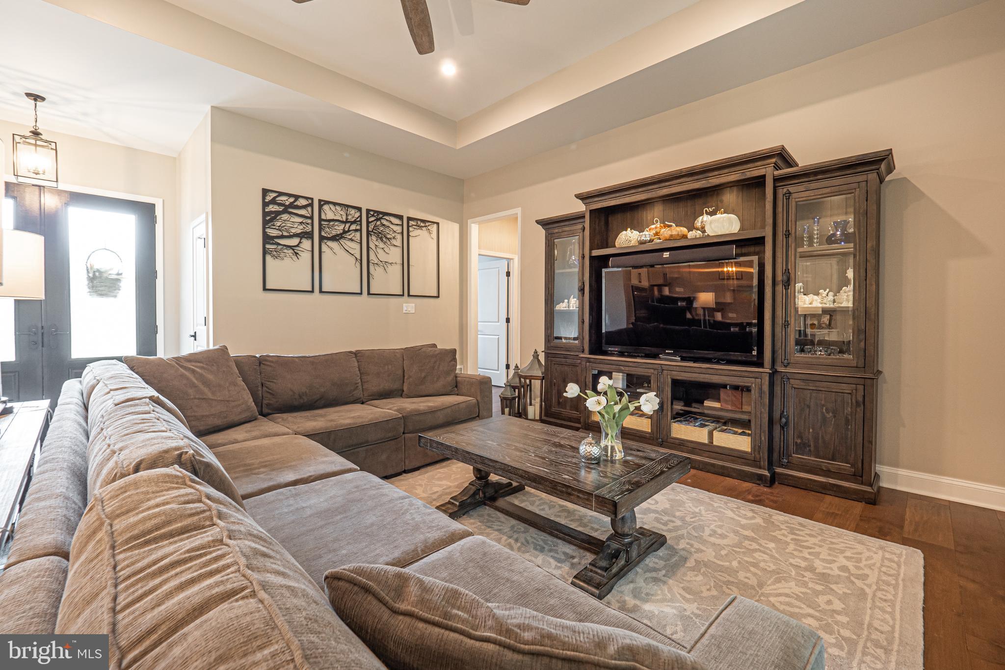 8 Timber Mill Lane, Unit TAGLIO Landenberg, PA 19350 - Photo 12 of 42 a living room with furniture and a flat screen tv
