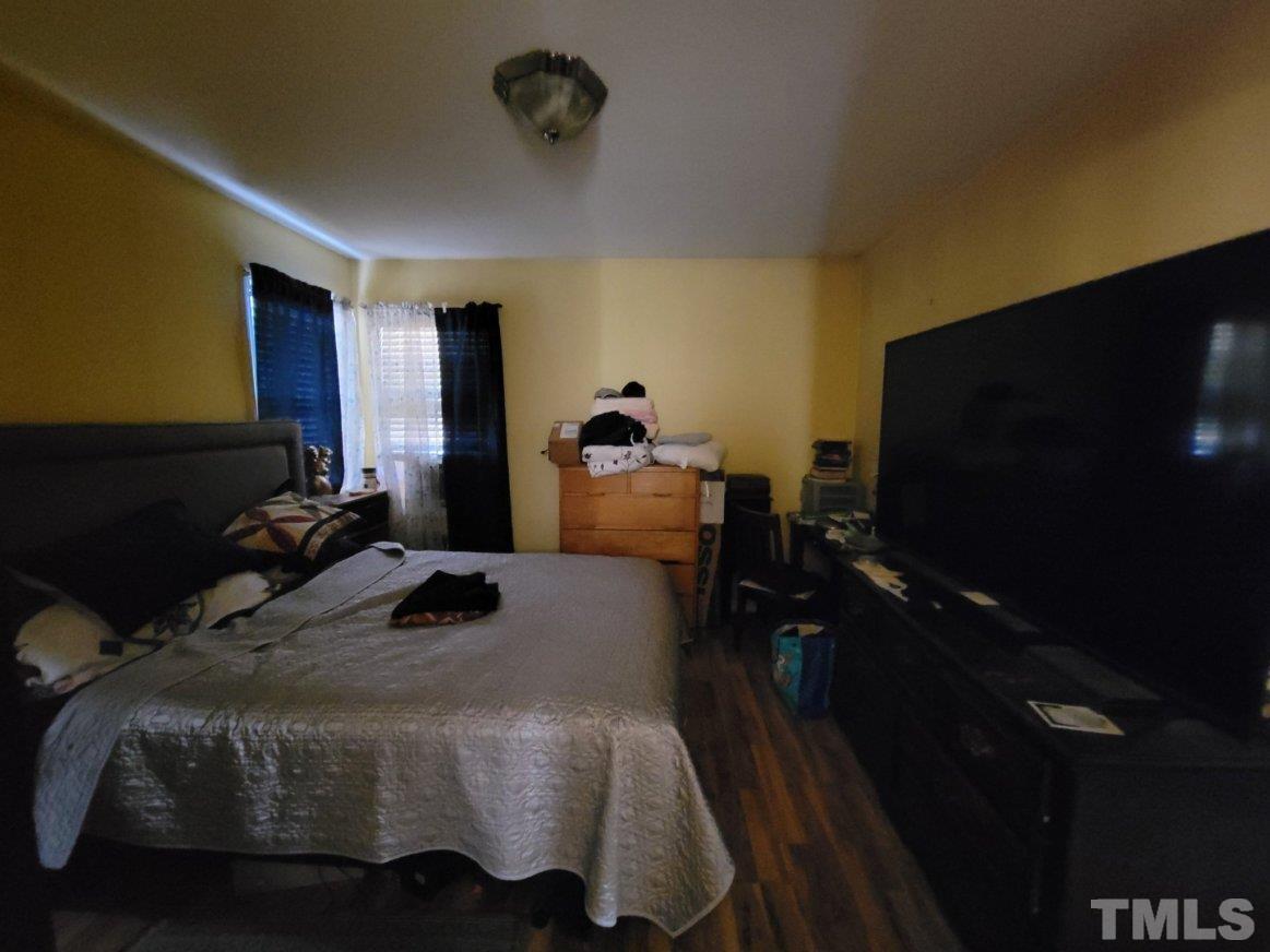 3336 Fairground Road Dunn, NC 28334 - Photo 3 of 11 a bedroom with a bed and flat tv screen